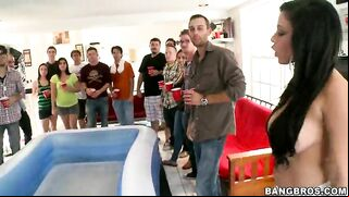Guys watch colleagues posing and shaking shapes in the pool