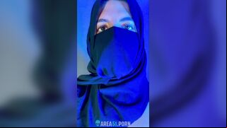 Muslim mistress wife in hijab putting a condom on big strapon
